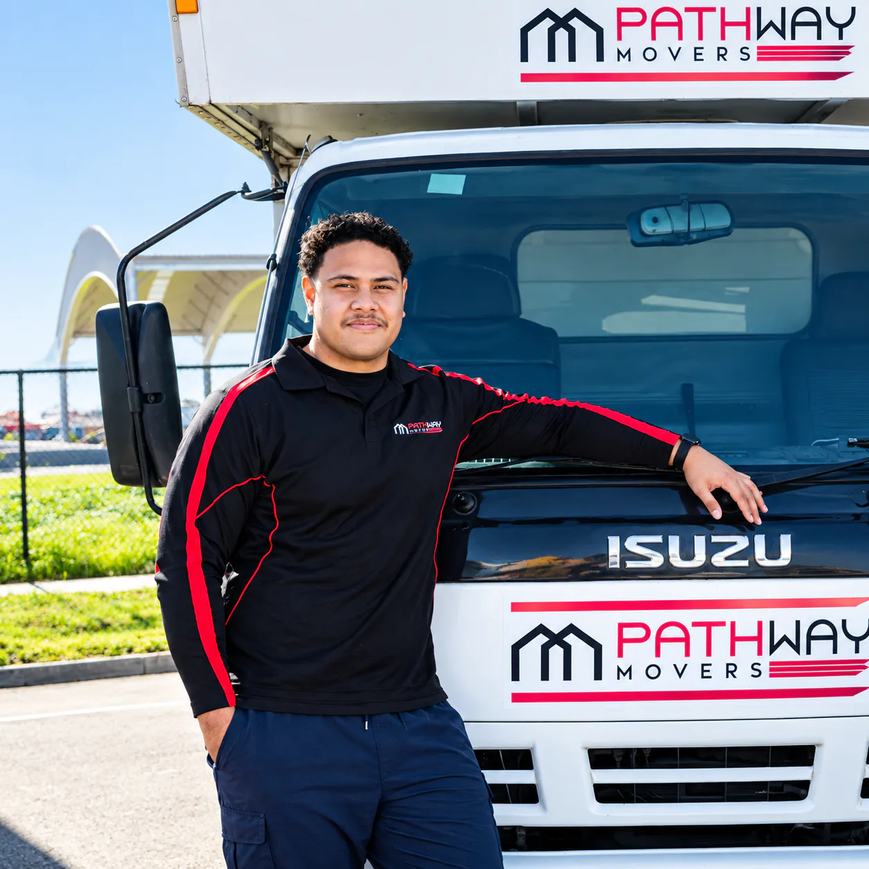 Pathway mover standing beside a company truck