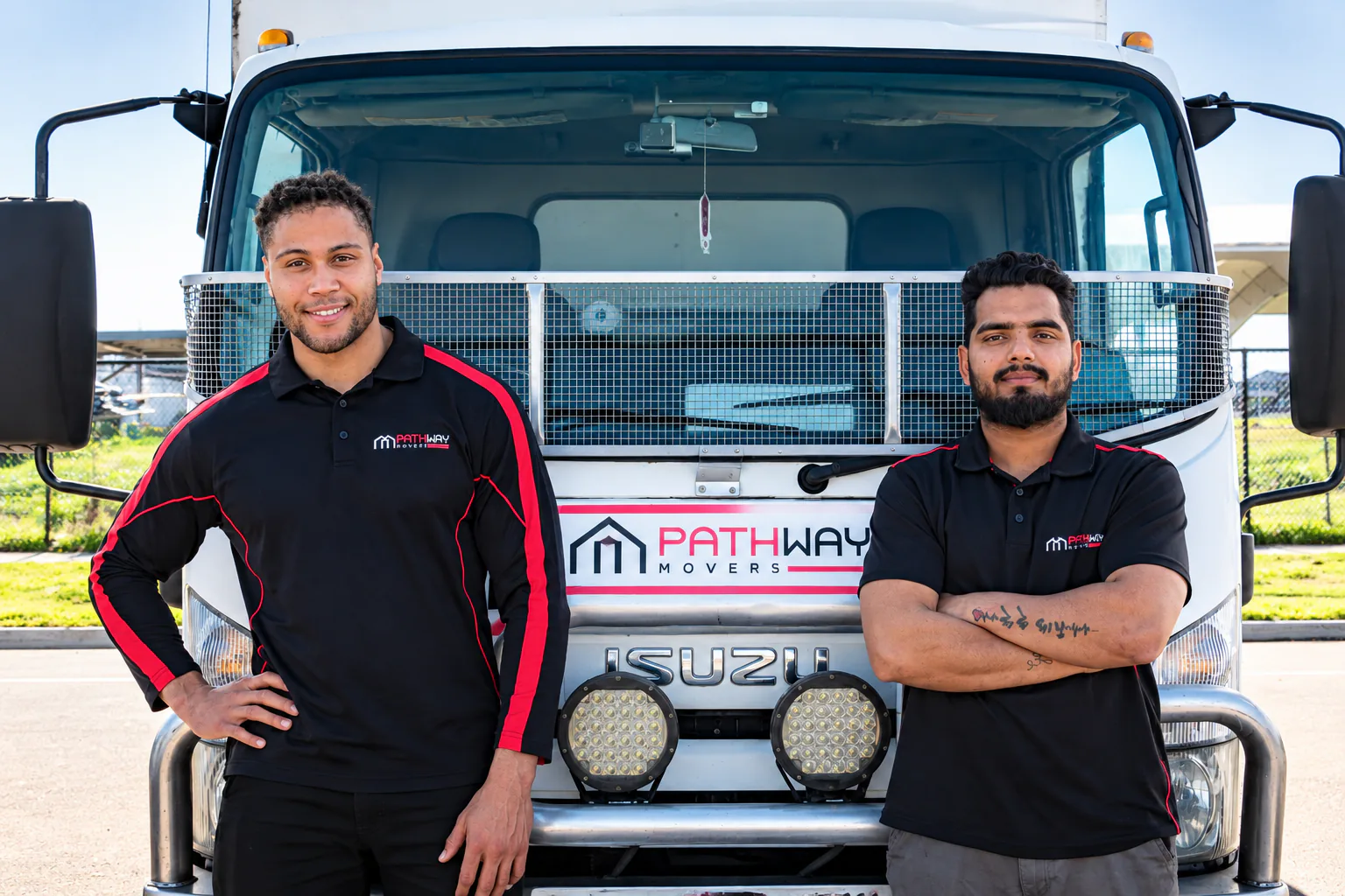 Two Pathway movers standing in front of their truck
