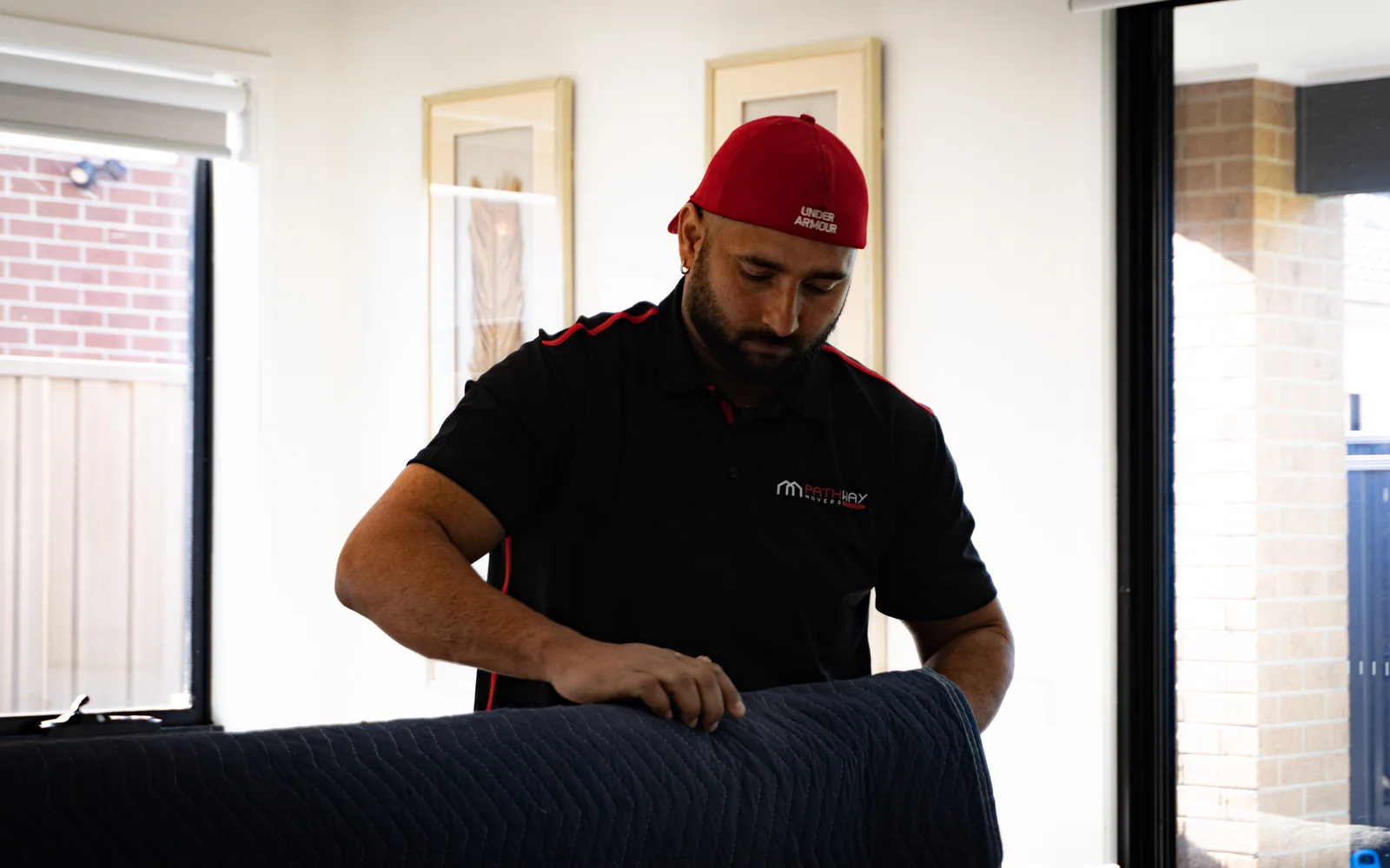 A Pathway Movers team member protecting furniture before transport