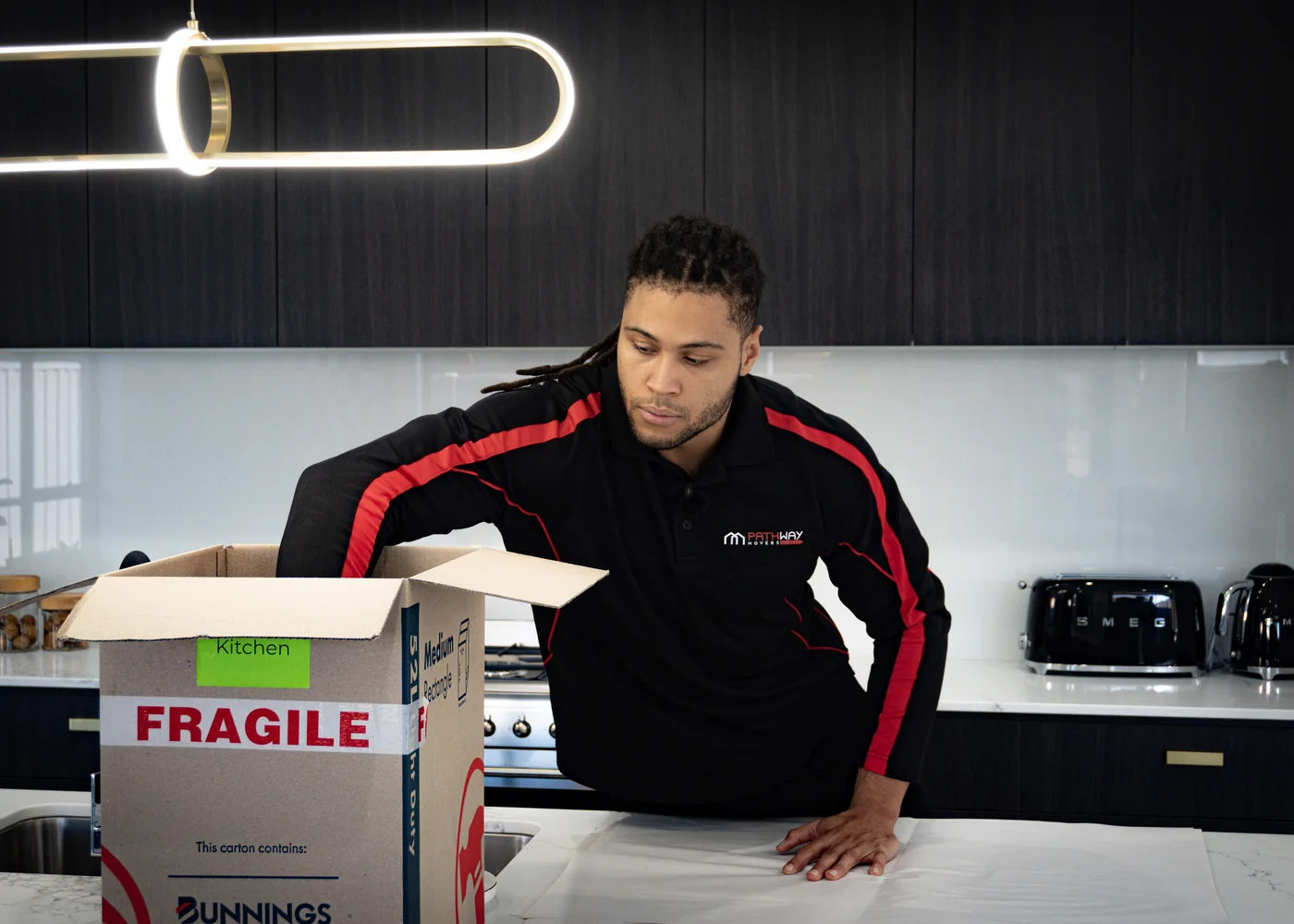 Pathway Movers team member packing fragile household items