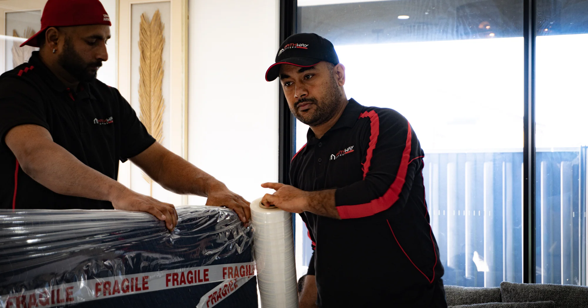 Pathway Movers team protecting customer furniture for transport